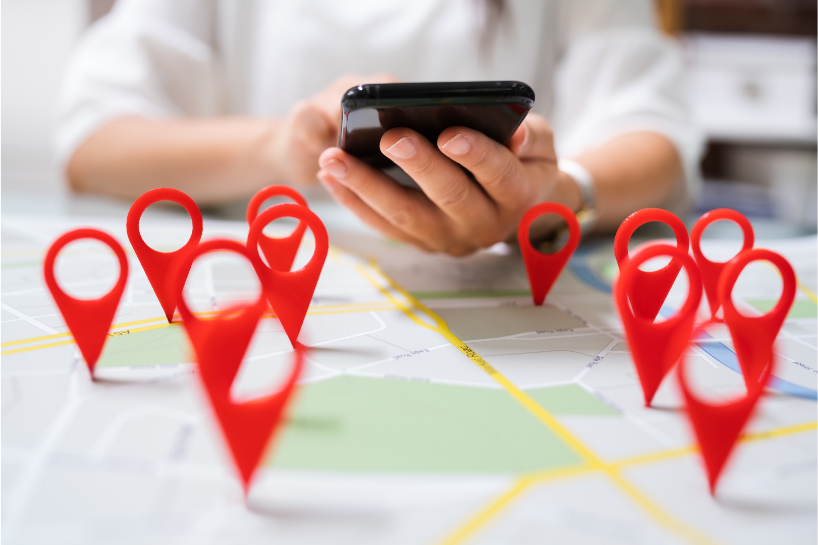 Local SEO design with red map location pins and smartphone for business visibility